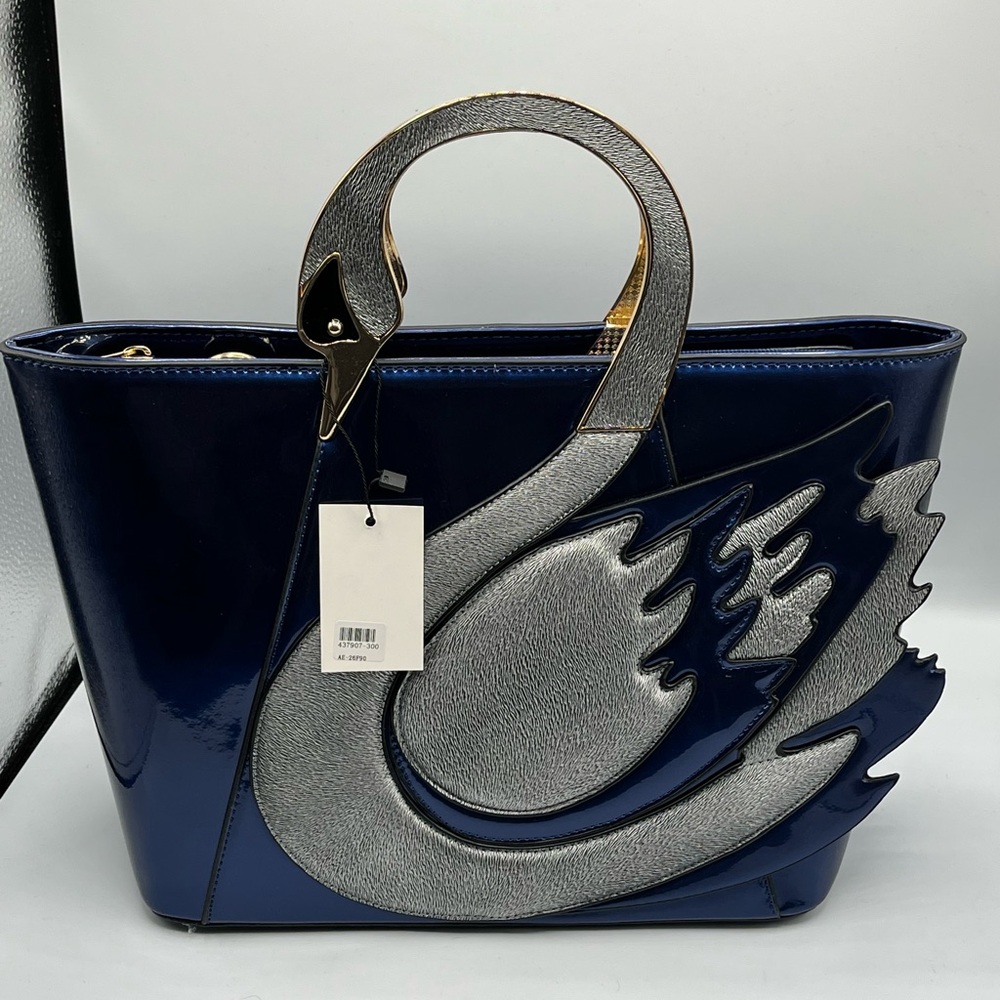 Very pretty swam style handle glossy hand bag .